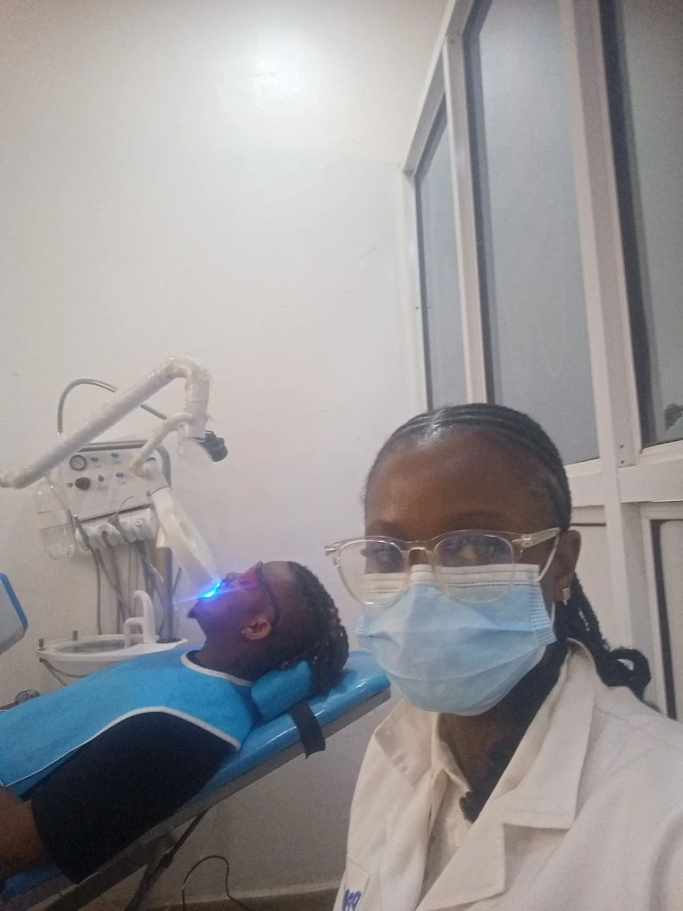 Dentist with patient under treatment light